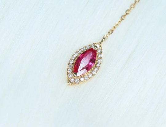 A ruby and diamond pendant set in gold