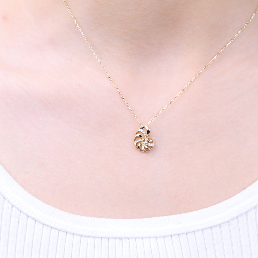 Gin and Grace in collaboration with Smithsonian Museum Collection presents a serene seashell pendant in 14K Yellow gold and Diamond for exclusive everyday look